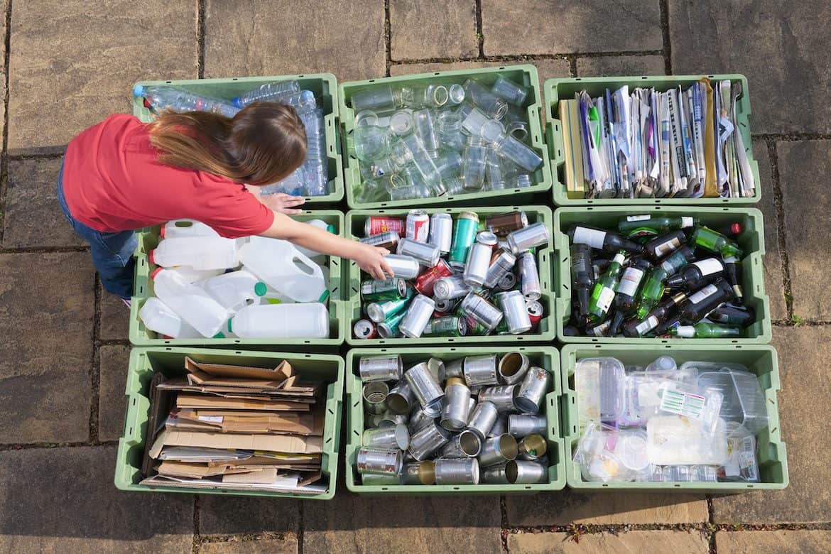 Girl organizing recycling bins